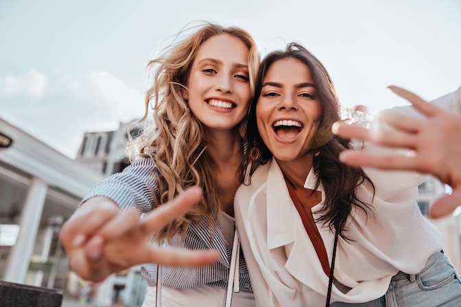 two young ladies enjoying being kind